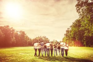 Teens standing in open field