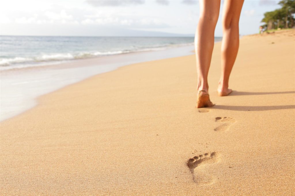 drug addicted woman walking on sand beach