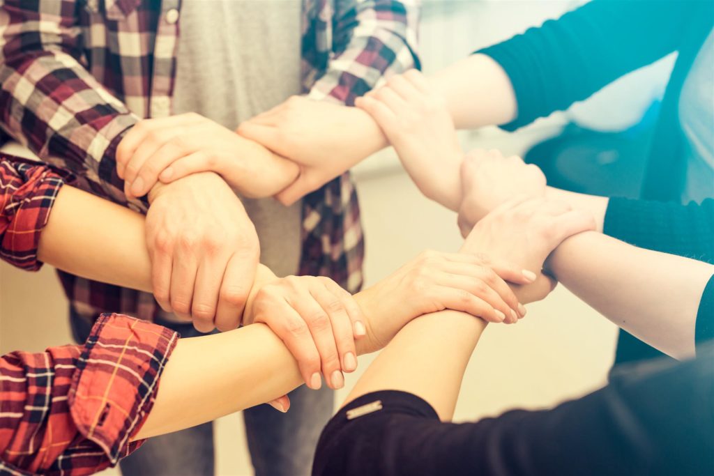 friends group holding hands in circle