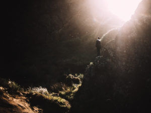 man at the bottom of a mountain