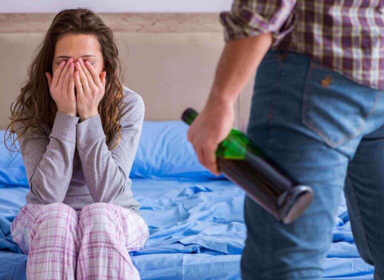 angry alcoholic man being mean to woman