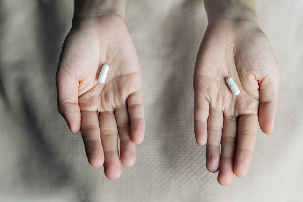 two hands hold fake xanax pills