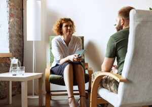 a therapist talks to a patient in an anger management program