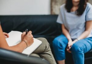 a person talks to a therapist in an anxiety treatment program