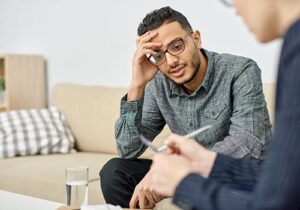 a person in a depression treatment program talks to a therapist