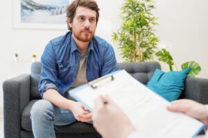 a person listens to a therapist during a heroin addiction treatment program