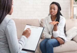 a person talks to a  therapist in a trauma treatment program