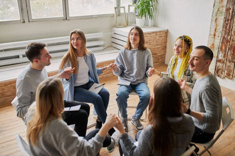 People sitting in a circle while talking about the benefits of luxury rehab