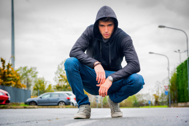 Man squatting and thinking about what "ice cream" is slang for